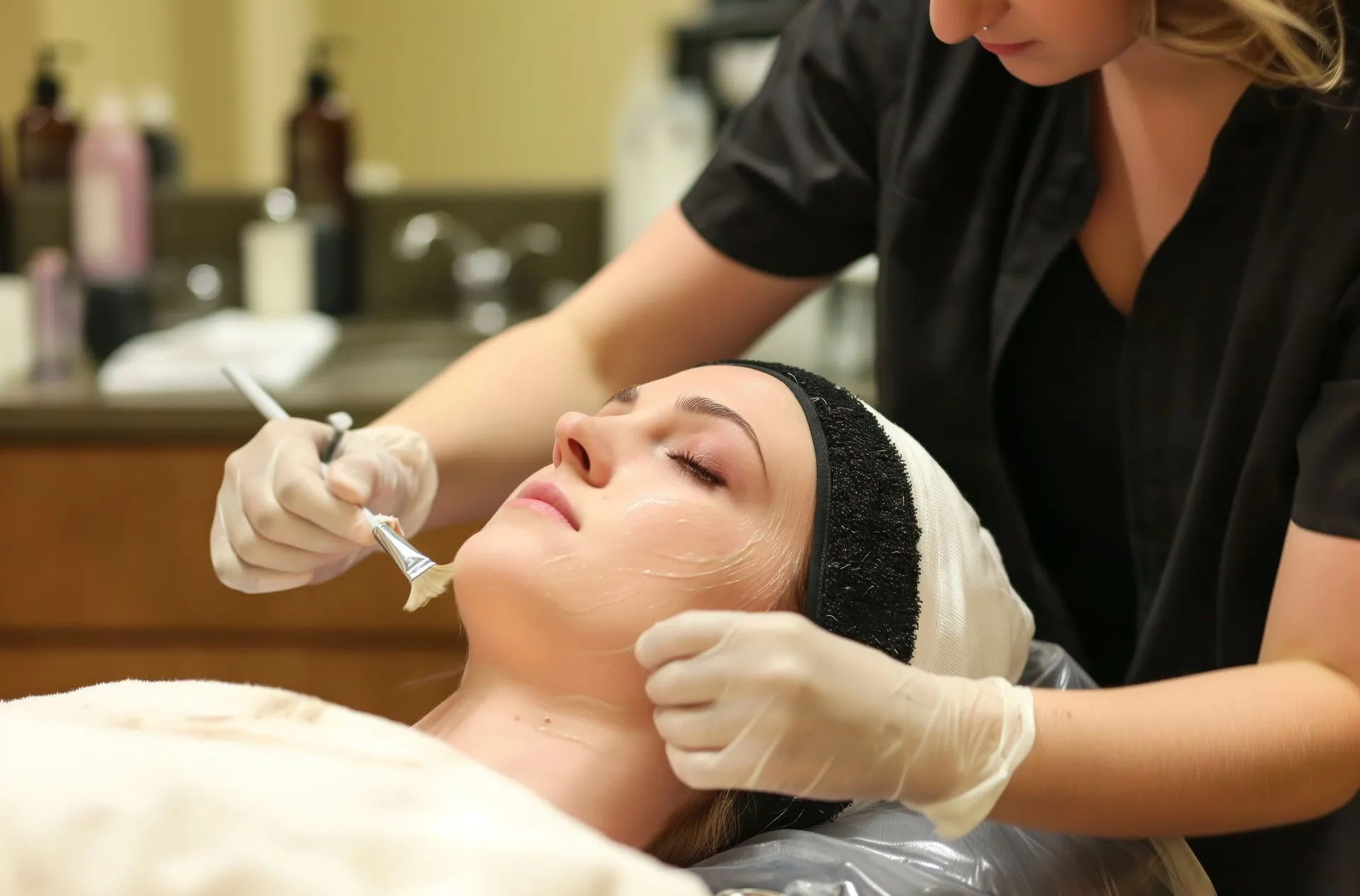 A woman is getting a facial treatment at a beauty salon.