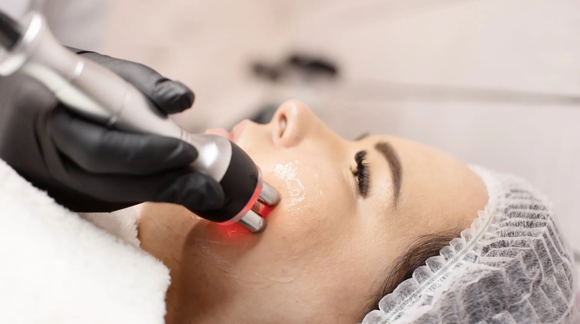A woman is getting a laser treatment on her face.