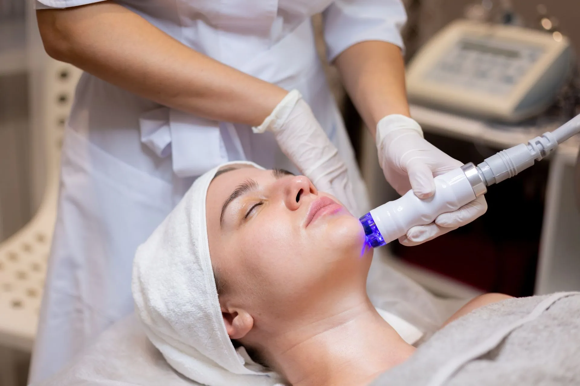 A woman is getting a facial treatment in a beauty salon.